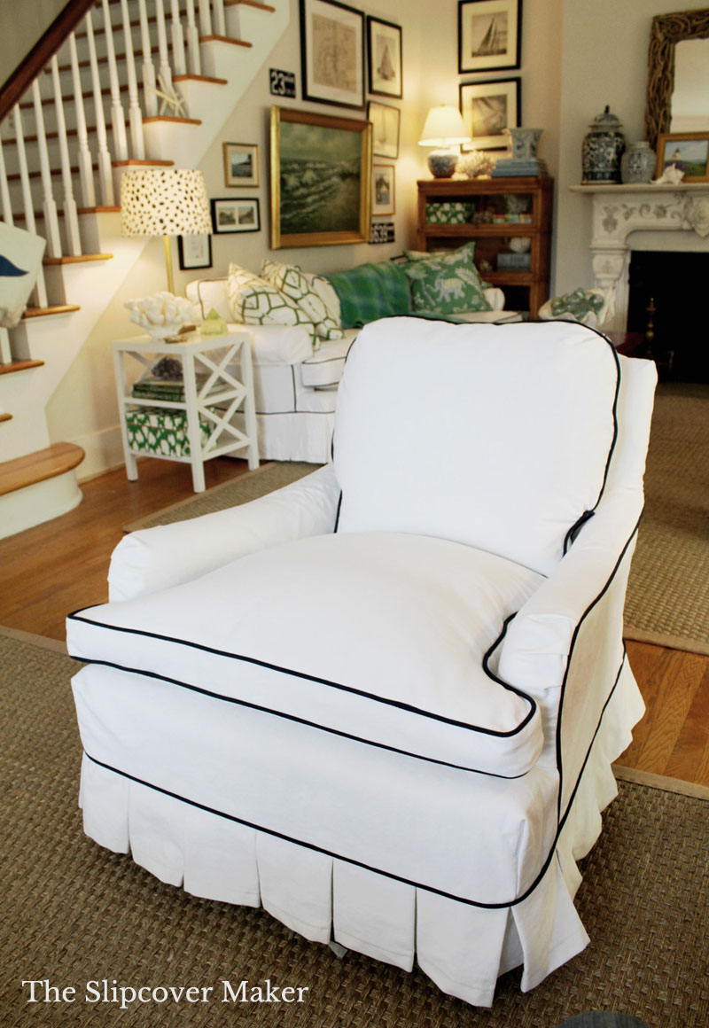 White Slipcovers Unify Multiple Seating Areas in this Charming Living Room