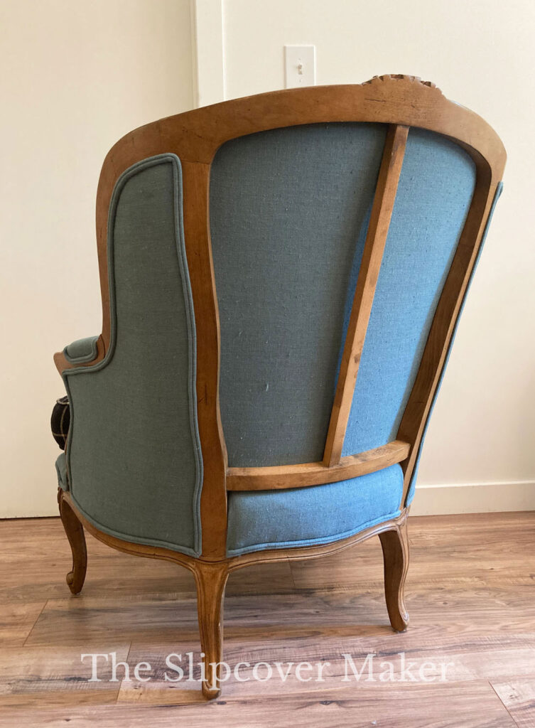 French chair back with exposed wood frame.
