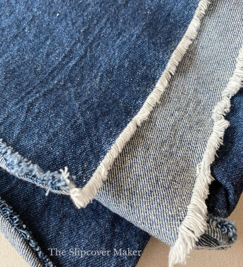 Washed indigo blue denim fabric sample.