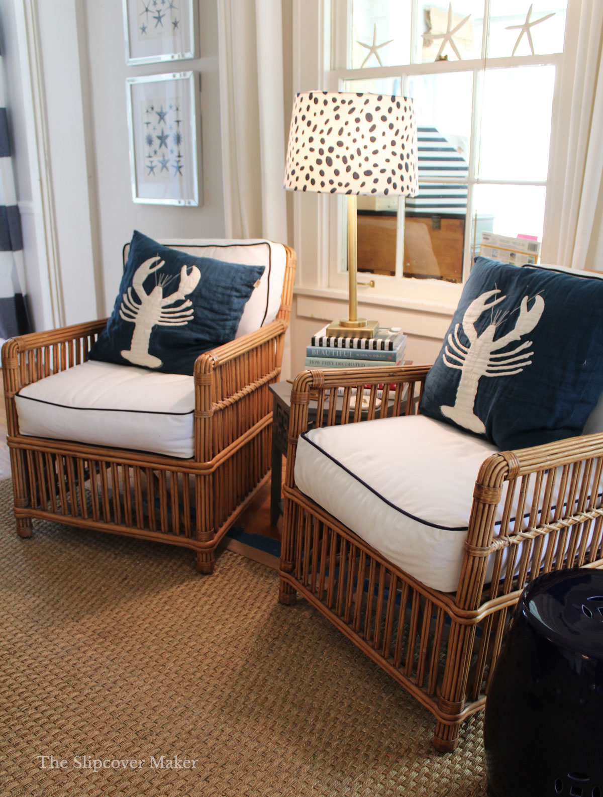 Rattan chairs in sunroom with white denim cushions.