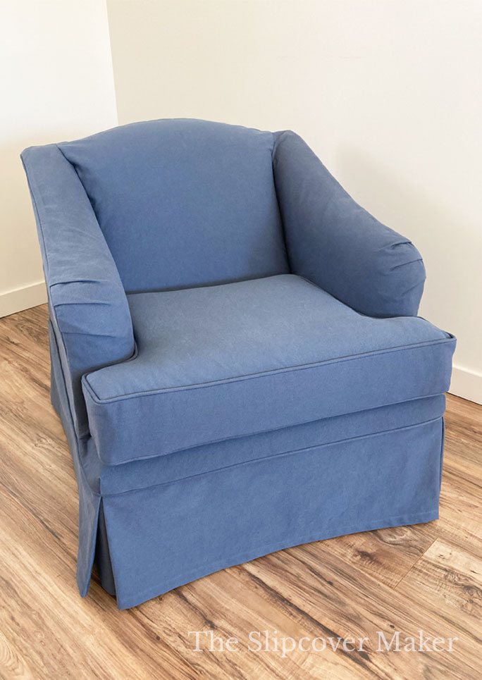 English rolled arm chair with blue cotton slipcover.