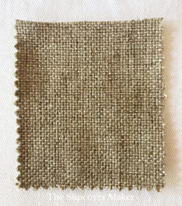 Brown fabric swatch with grainy weave.