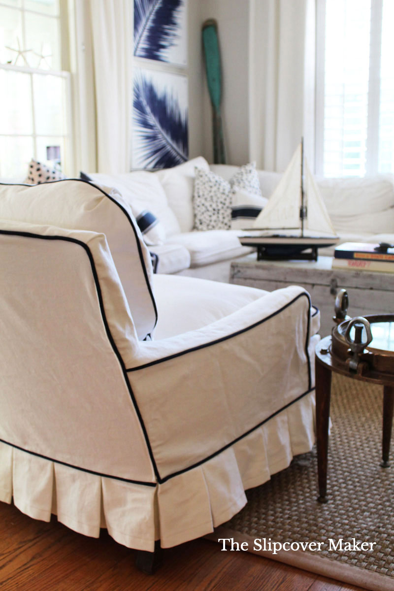 White slipcovered chair in living room. 