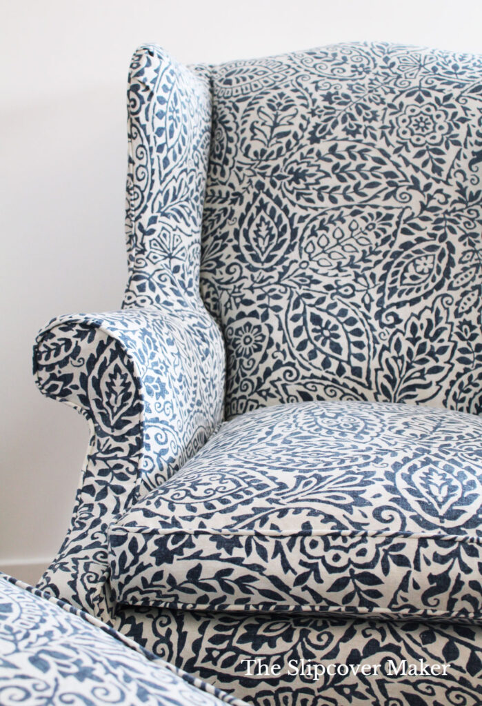 Wing back chair with box cushion in blue and white.