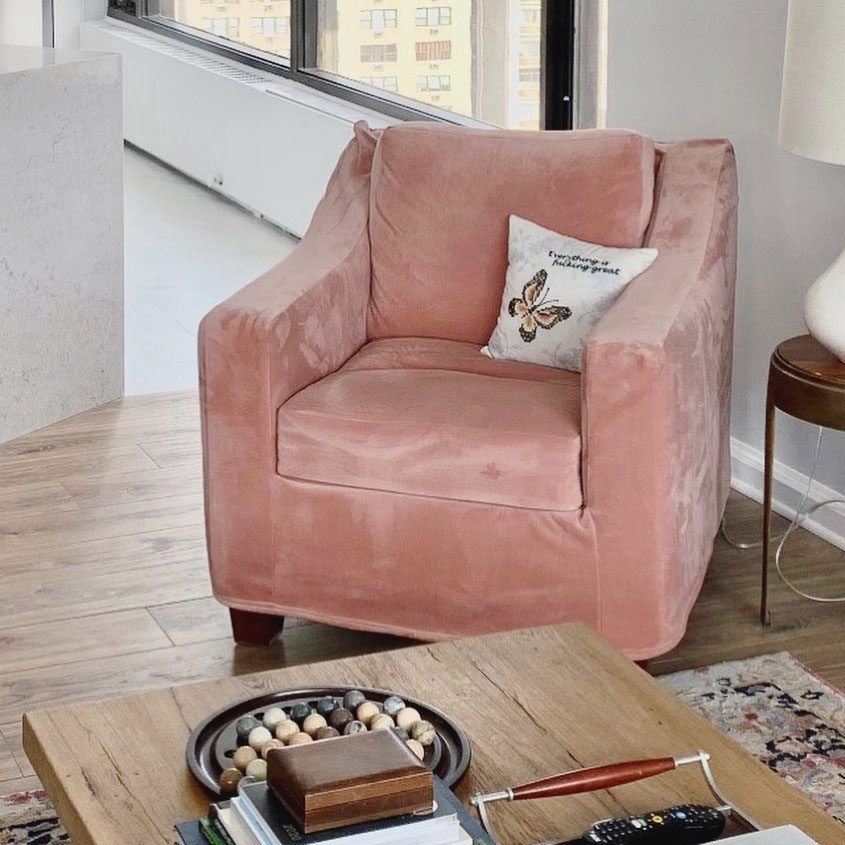 Pink velvet slipcover on armchair.