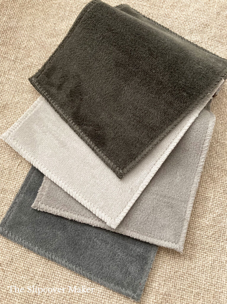 Swatches of polyester velvet fabric in neutral colors.