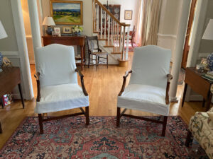 White slipcovered side chairs.