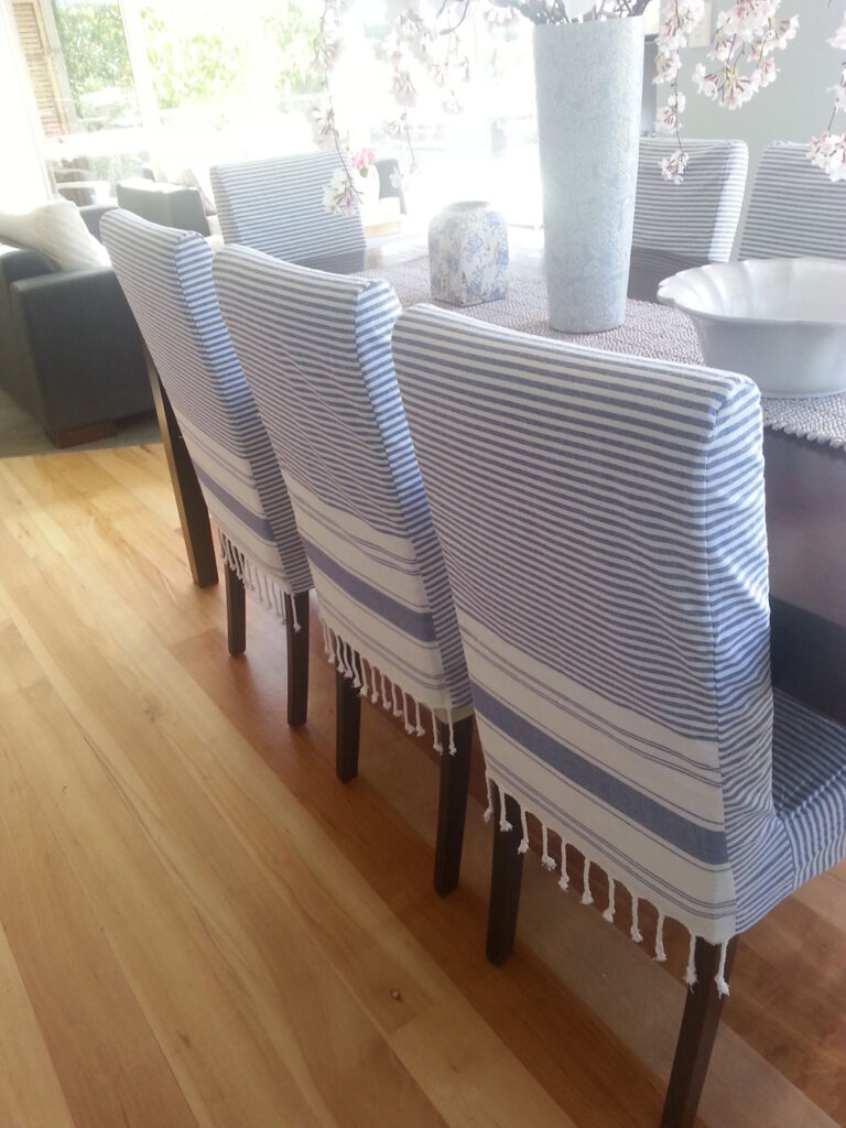 Blue chair slipcovers made from throw blankets.