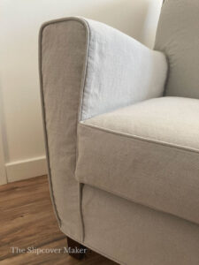 Close up of chair arm showing slipcover details.