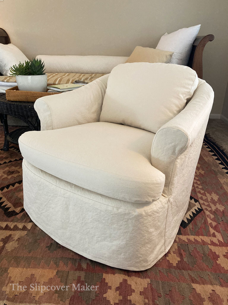 Barrel chair with natural canvas slipcover.