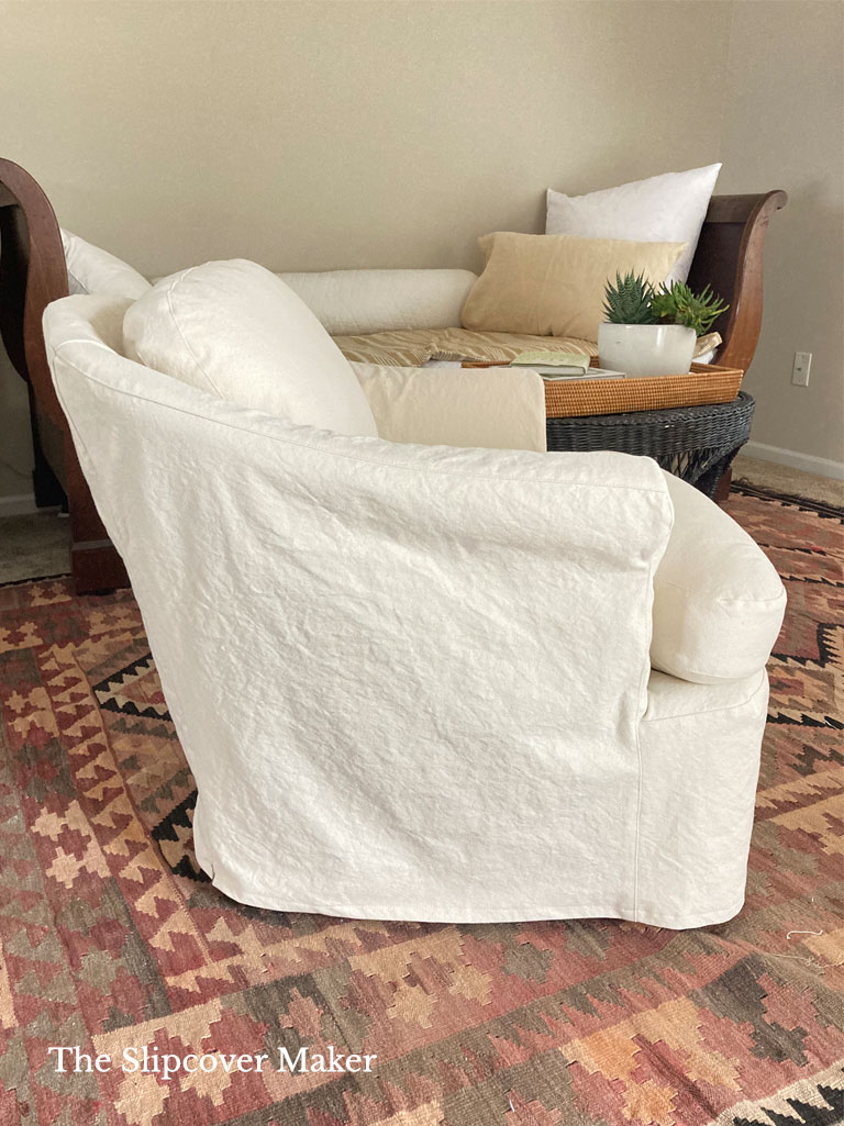 Natural canvas slipcovered chair in living room.