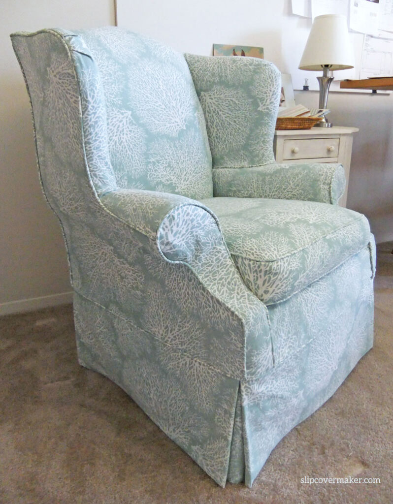 Coral print slipcover for big wingback chair.