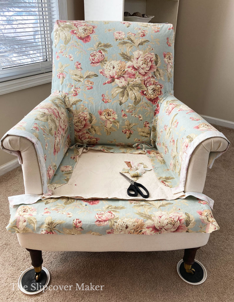 Cotton floral slipcover pin fit in process on chair.