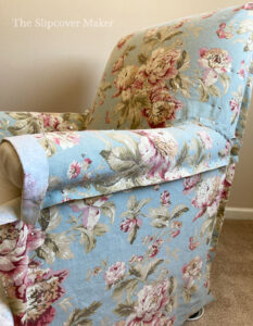 Floral cotton slipcover pinned to chair.
