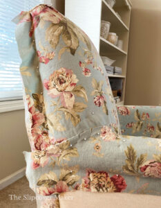 Cotton floral fabric slipcover pinned seams.