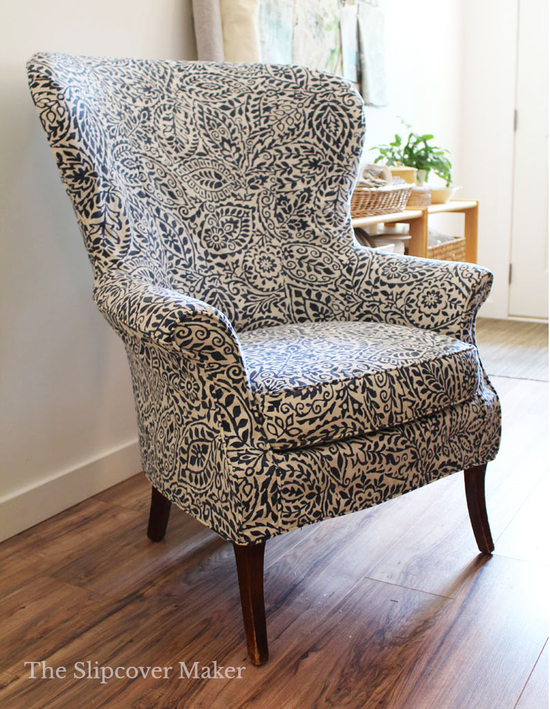 Blue and white leaf print fabric slipcover for chair.