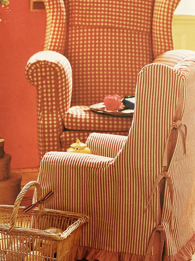 Orange stripe chair slipcover with ties.