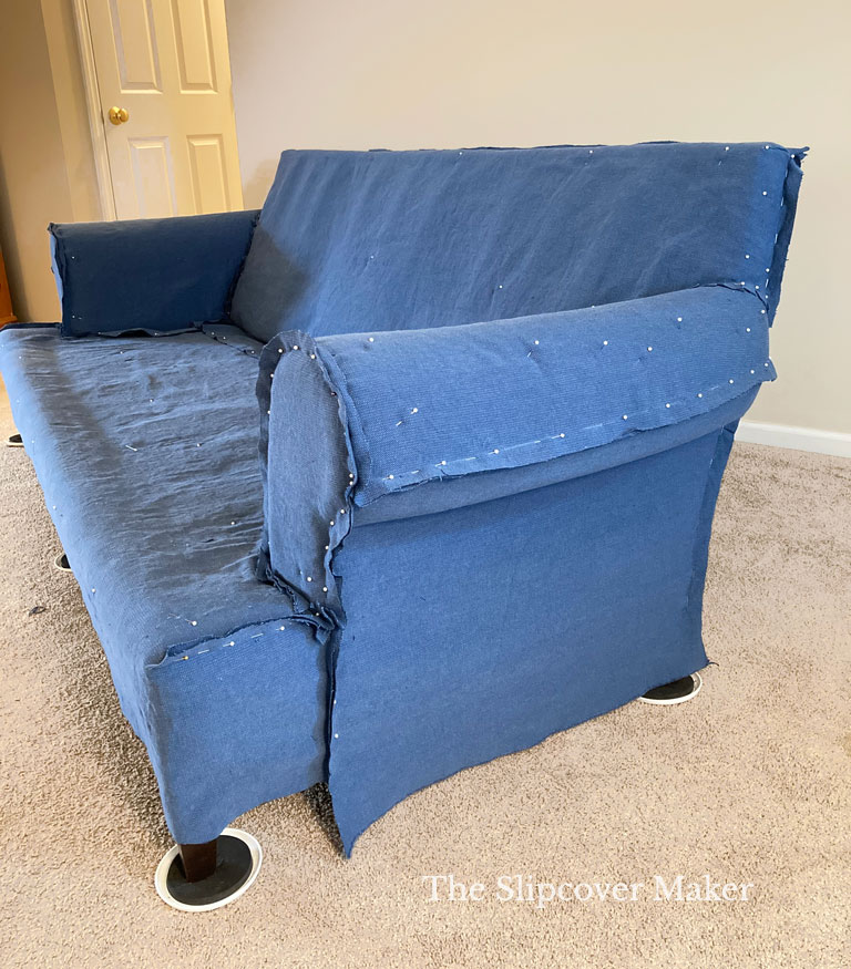 Blue canvas slipcover pin fitted on sofa.