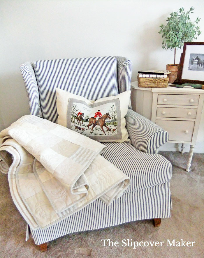 Wingback chair with blue ticking stripe slipcover.