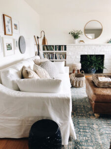 White slipcovered sofa in eclectic living room.