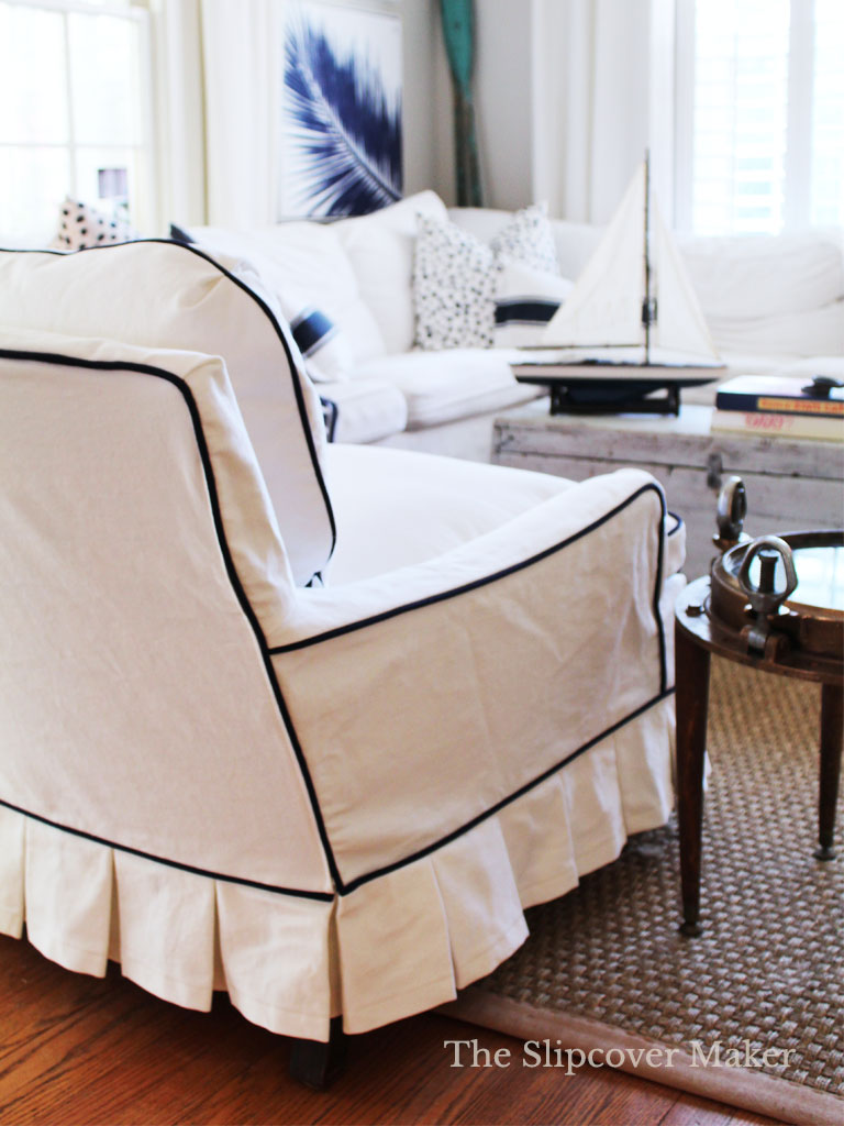 Living room with white slipcovered furniture.