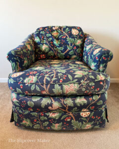 Old navy blue floral upholstered swivel armchair.