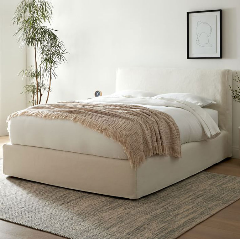 white linen slipcovered bed