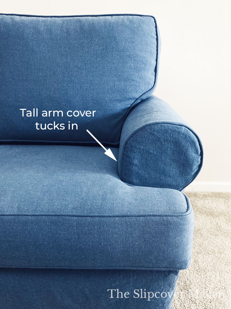 Blue arm chair with deep arm covers.