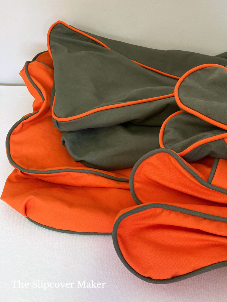 Bright orange and green slipcovers with contrast welt cord.