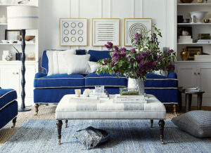 Blue sofa slipcover with white piping in the living room.