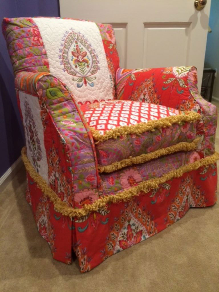 Chair red quilted slipcover with gold fringe trim.