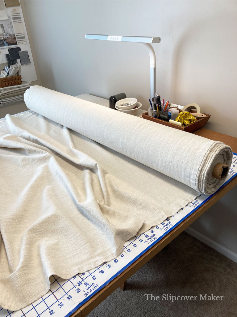 Fabric roll on slipcover work table.