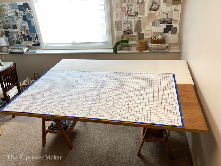 Slipcover work table with cardboard cutting mat.