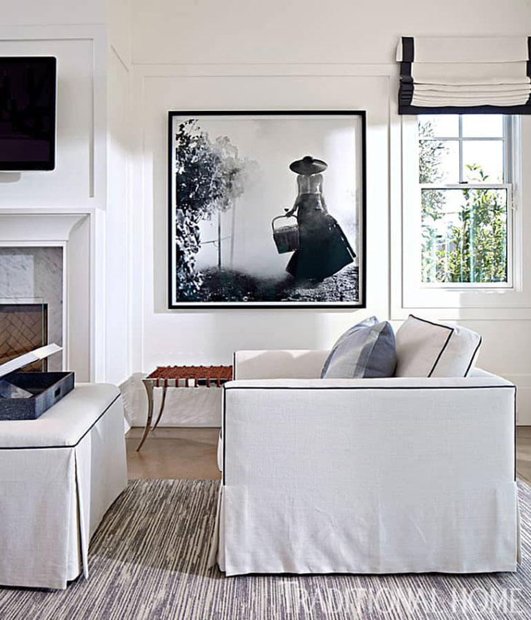 White slipcover with navy piping on a boxy chair.