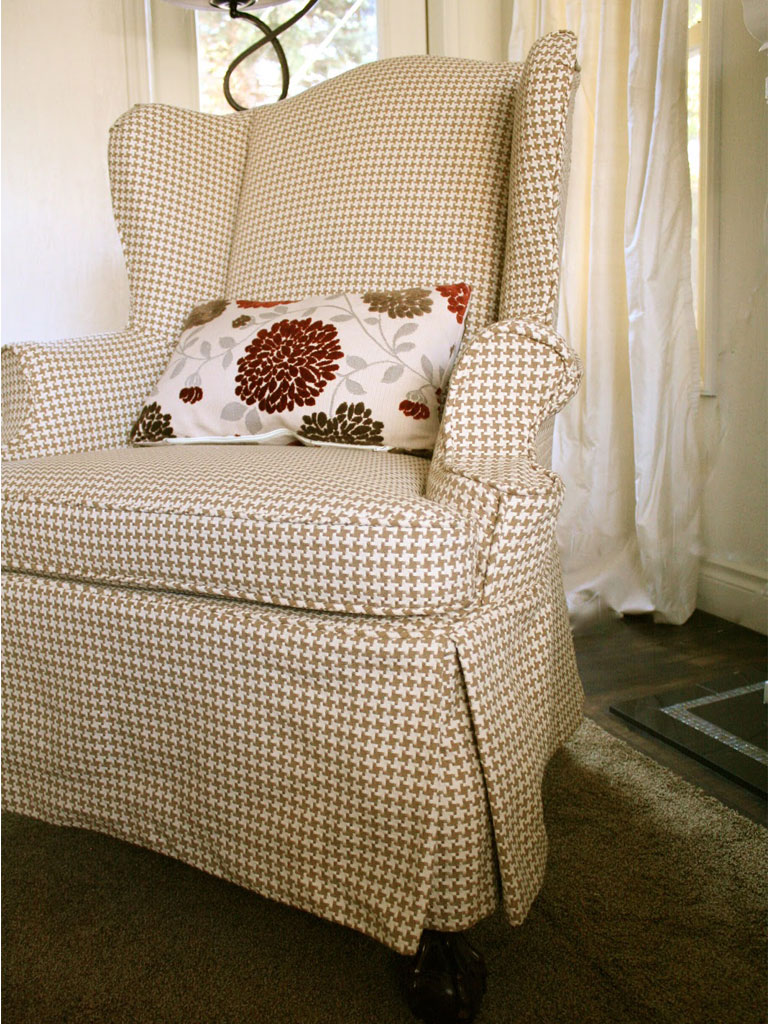Houndstooth slipcovered wingback chair.