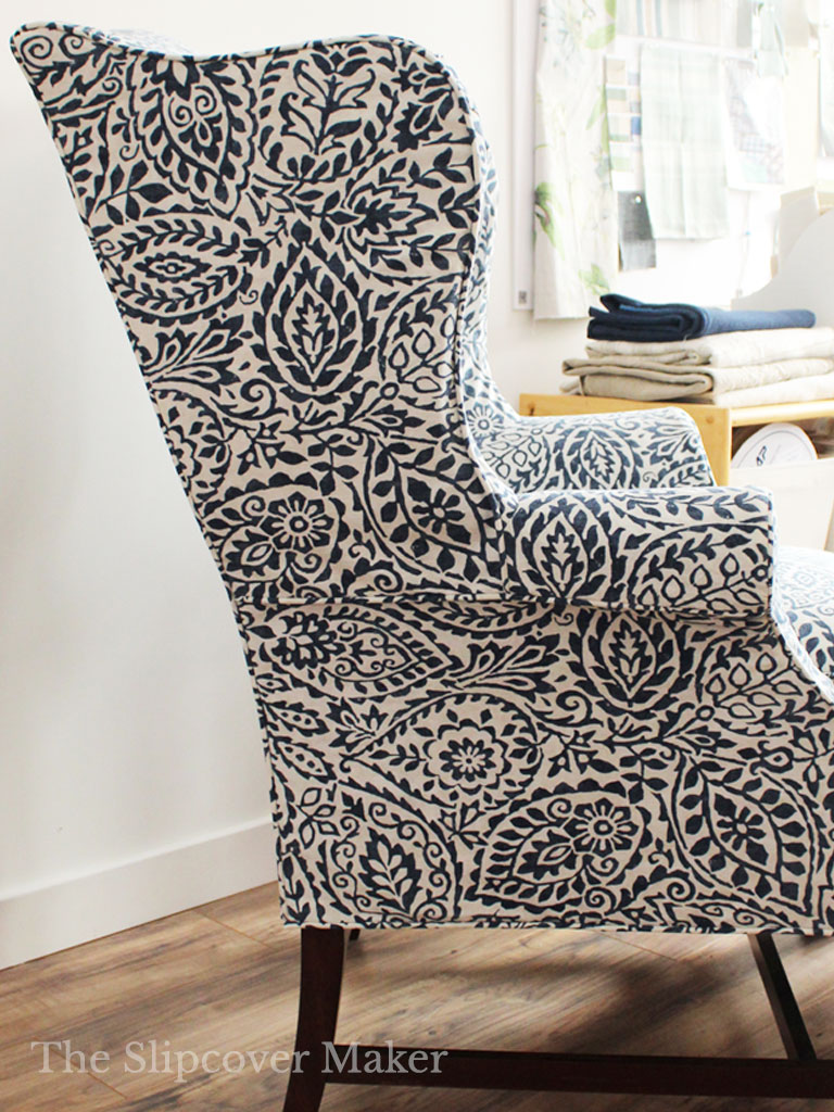 Blue and white leaf print slipcover on wingback chair.