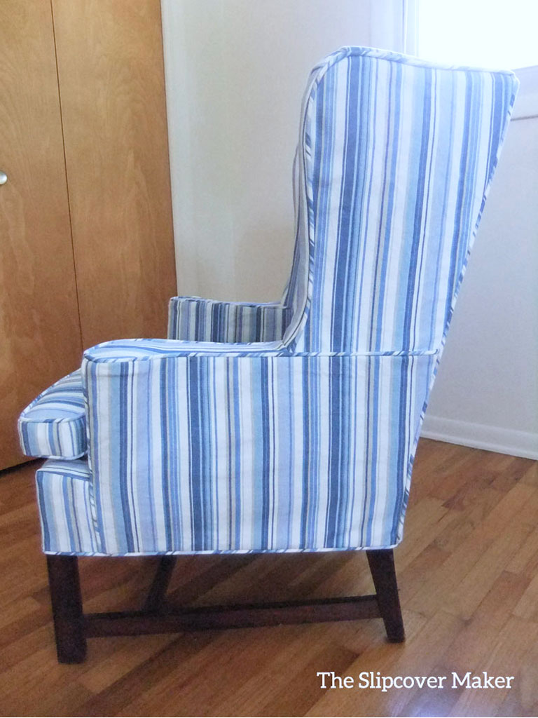 Blue striped slipcover on a wingback chair.