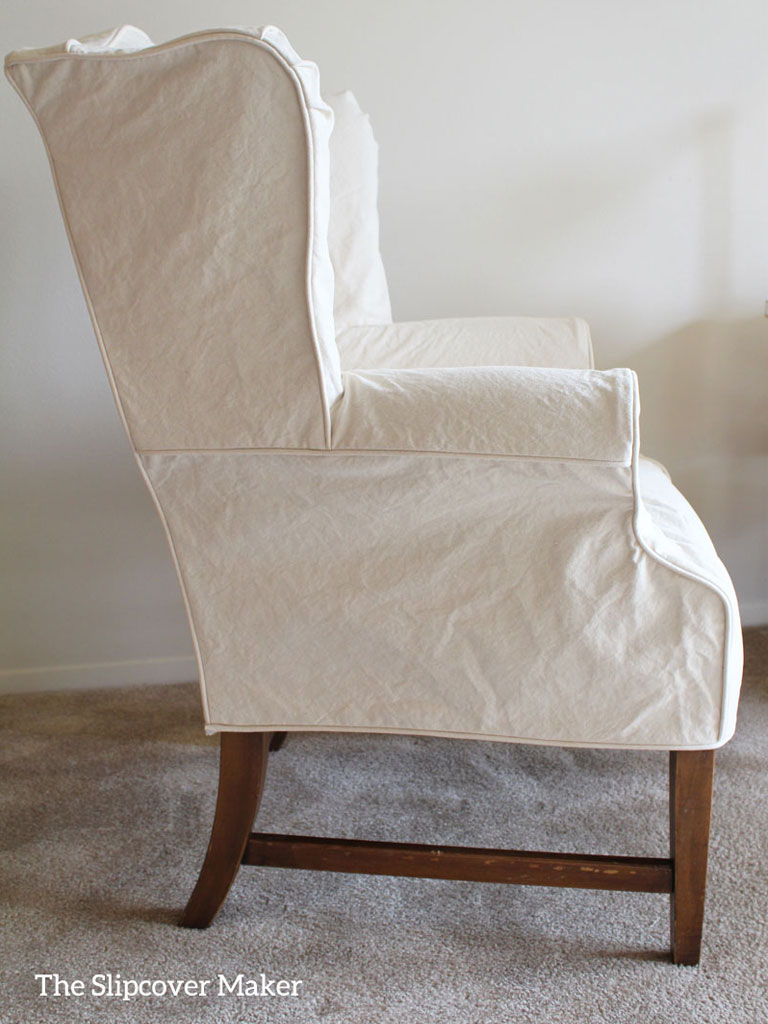 Wingback chair with natural canvas slipcover.