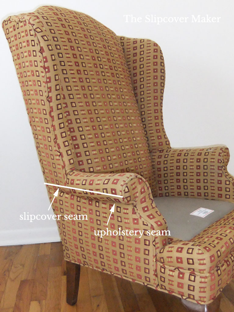 Brown wingback chair with arm seam placement.