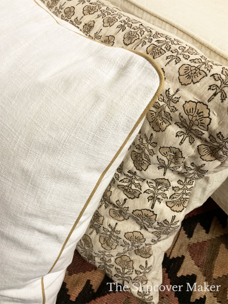 Linen pillow with tan welt cord trim.