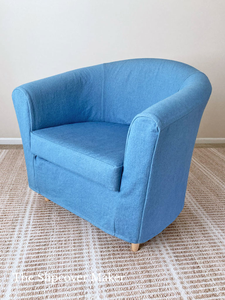 Blue denim slipcover barrel back chair, corner view.