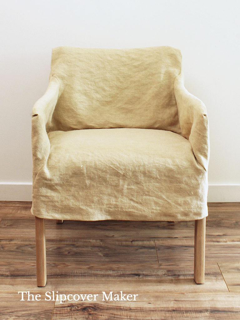 Loose fit natural hemp canvas slipcover on chair.