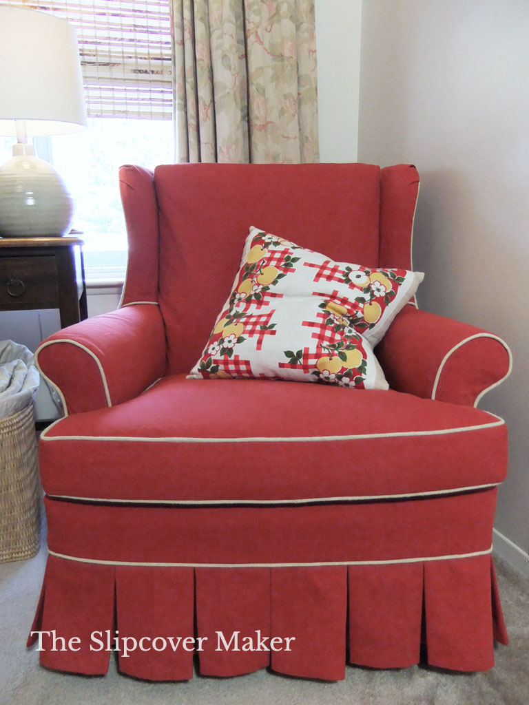 Red canvas slipcover on wingback chair.