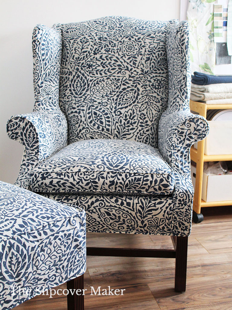 Blue floral slipcover on wingback chair.