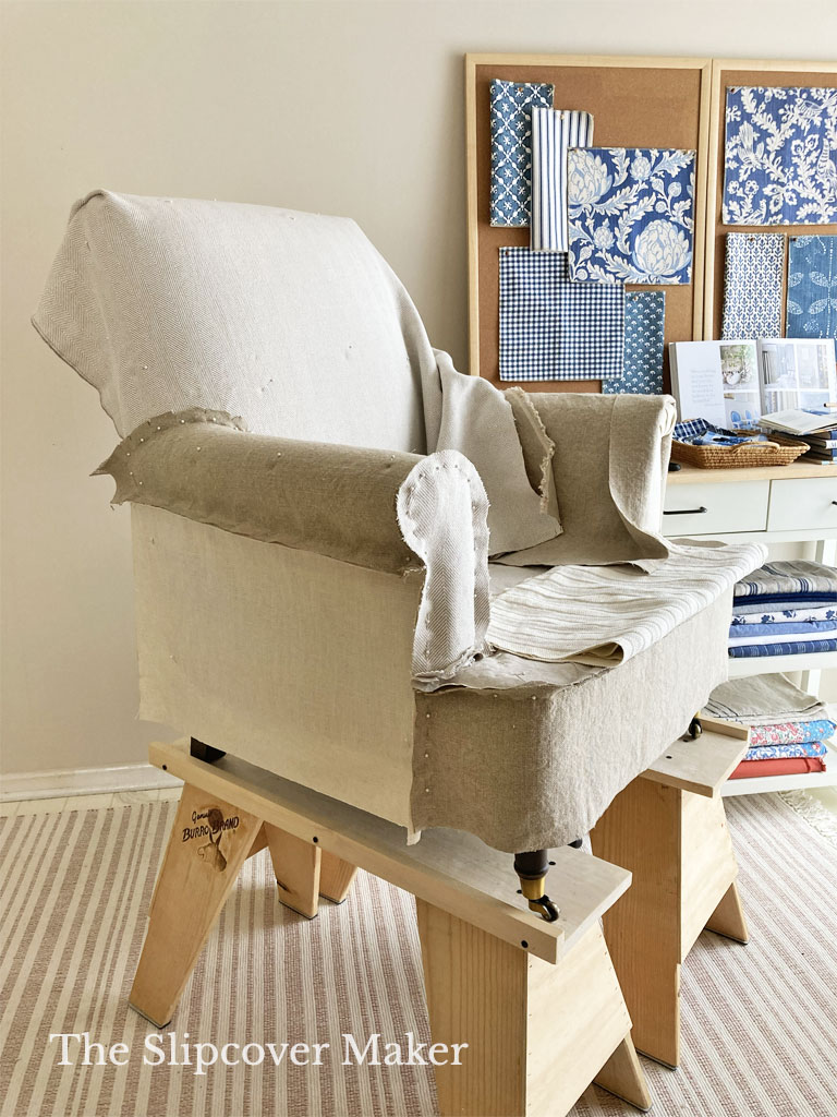 Pin fitting natural linen and cotton chair slipcover.