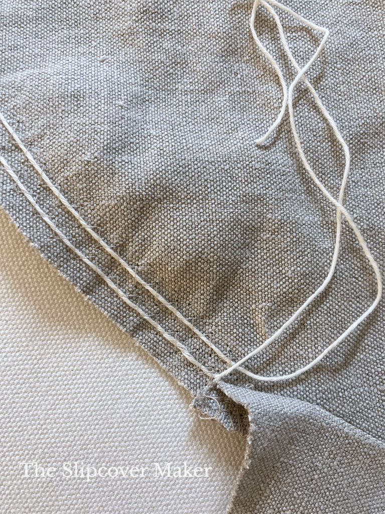 Gather strings on hemp canvas slipcover arm.