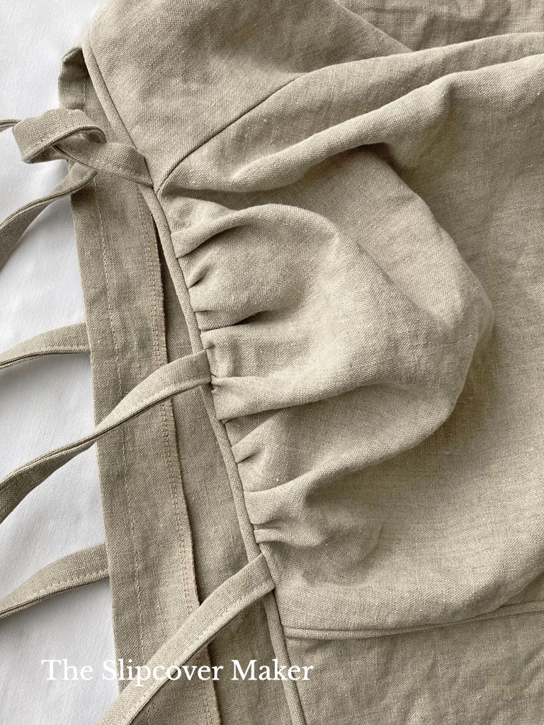 Hemp canvas slipcover laying flat showing gathered back arm.