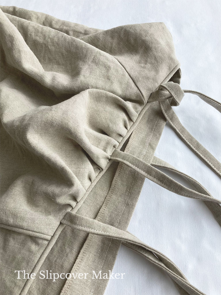 Hemp sofa slipcover gathers and ties on arm.