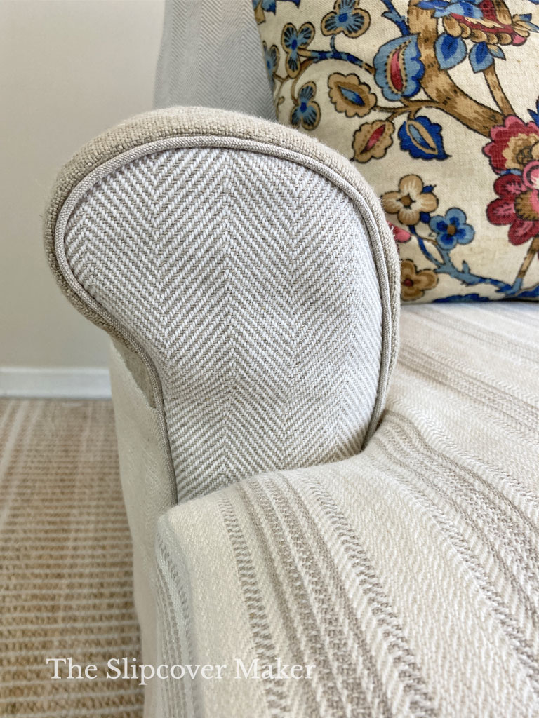 Front arm of linen and cotton chair slipcover.