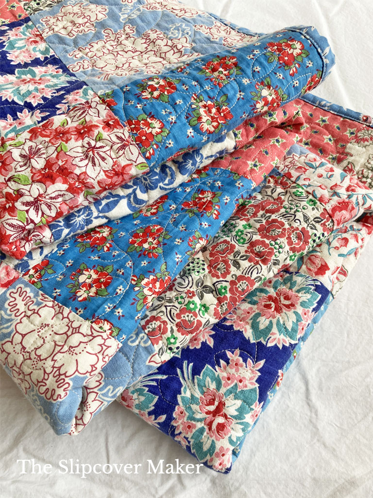 Feed sack patchwork quilt.